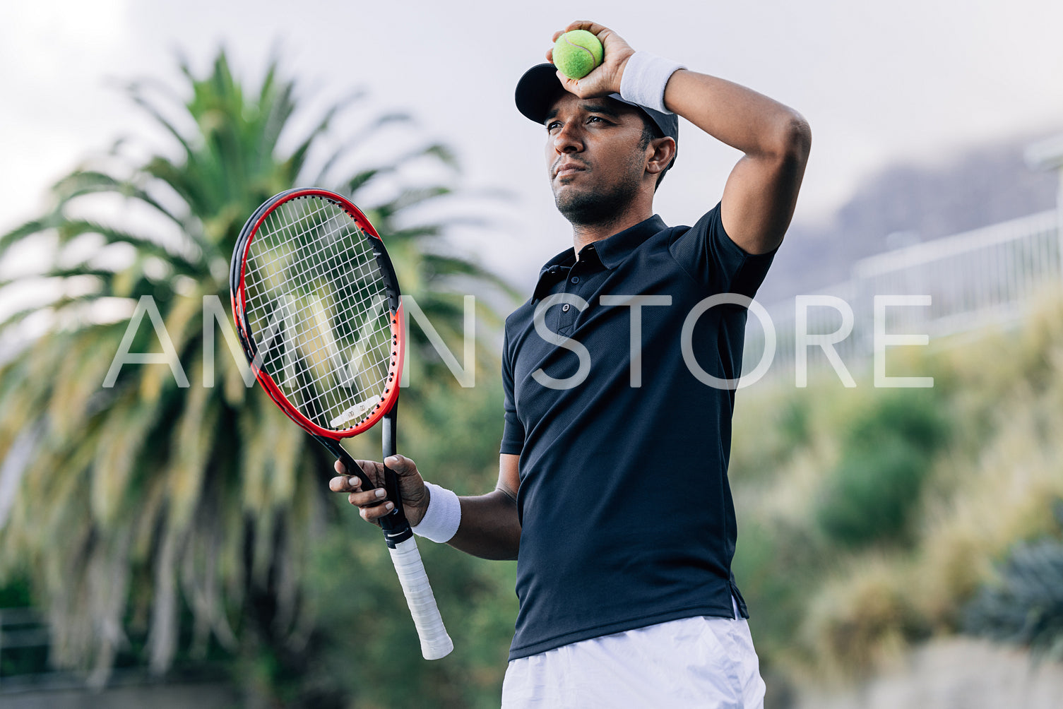 Professional tennis player wearing sports clothes holding racket and tennis ball