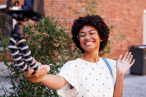 Happy woman recording video on dslr camera