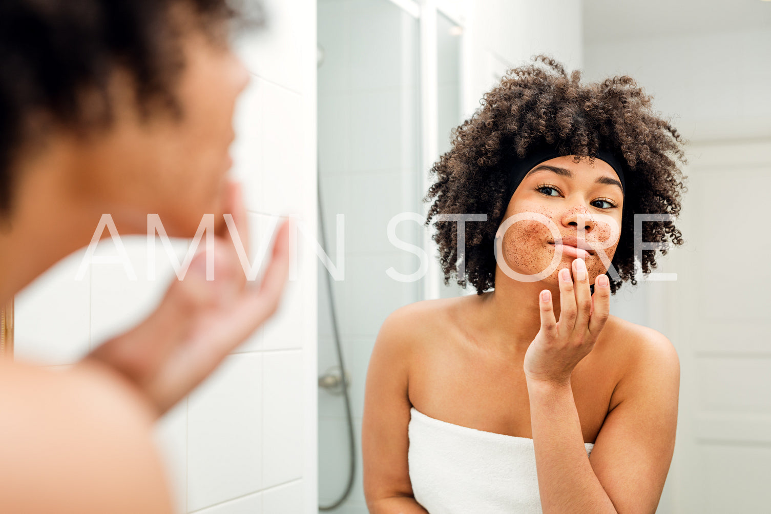 Beautiful girl with cosmetic scrub on her face	