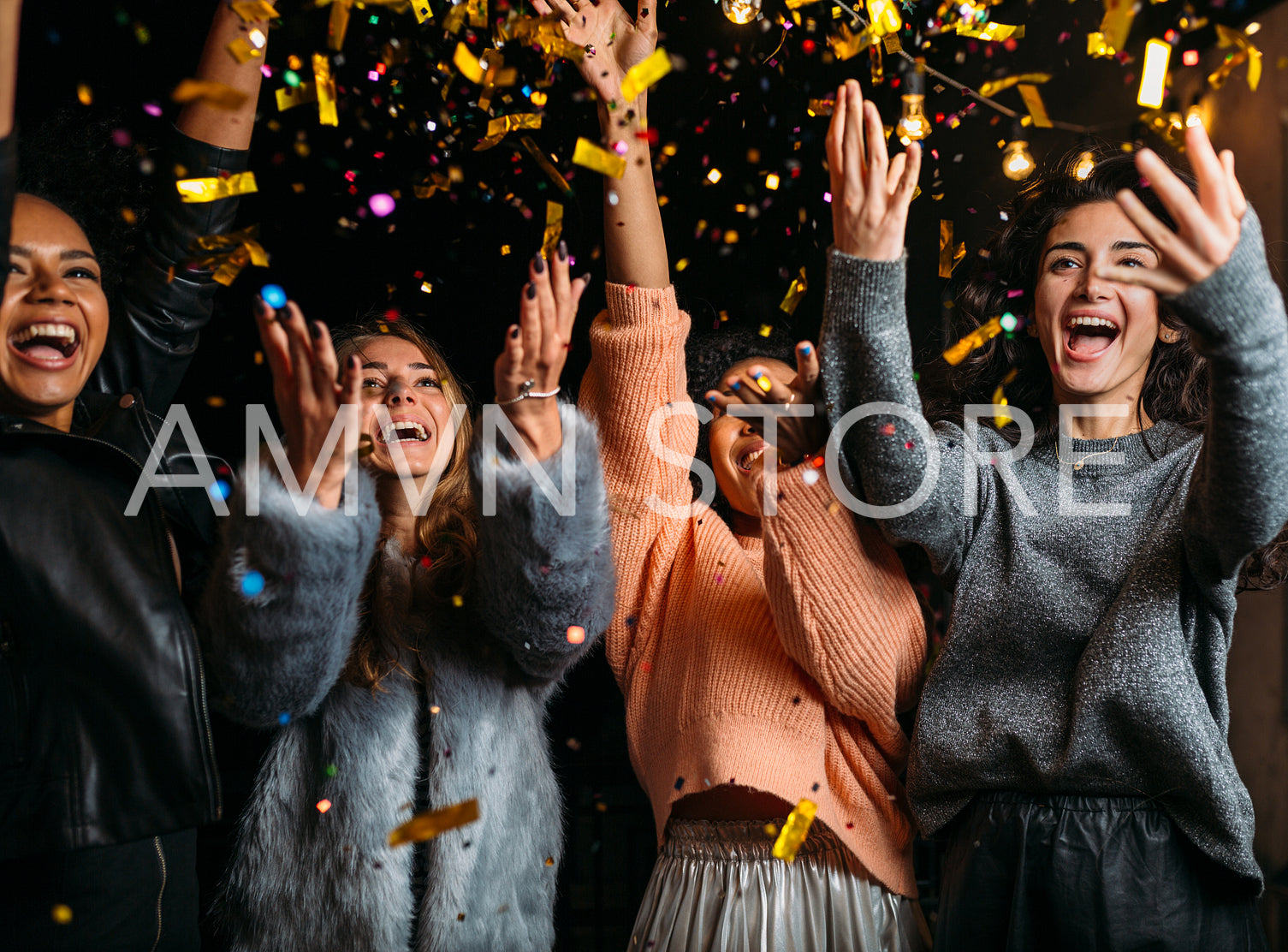 Outdoor shot of happy friends. Happy women throwing confetti at a party.	