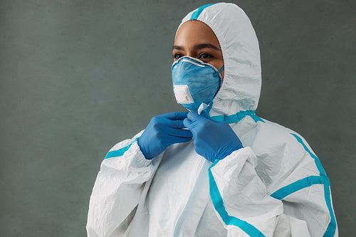 Medical specialist zipping up protective suit preparing for work during a pandemic