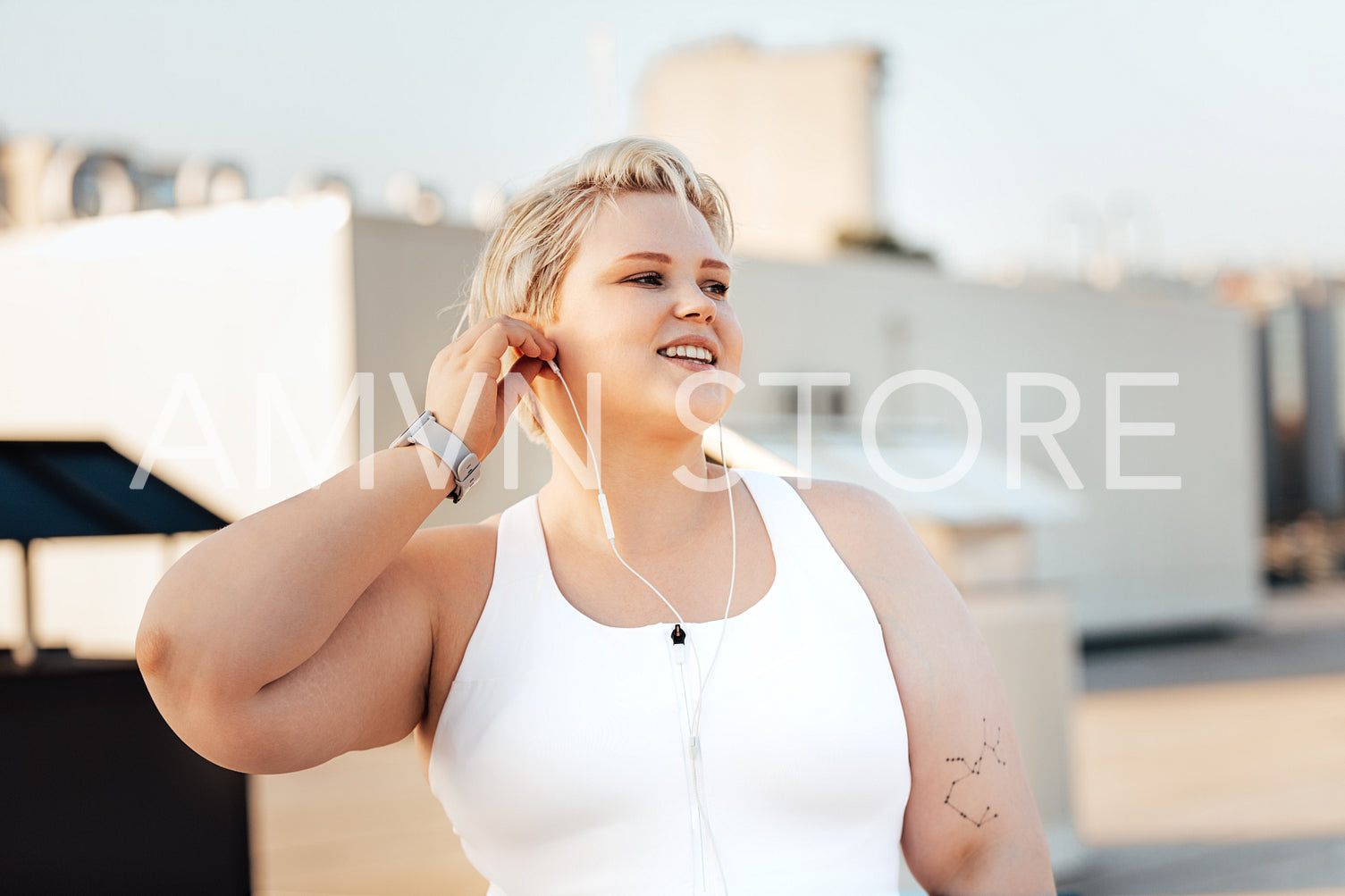 Happy curvy woman standing on a roof. Young oversized female taking a break during exercises.	