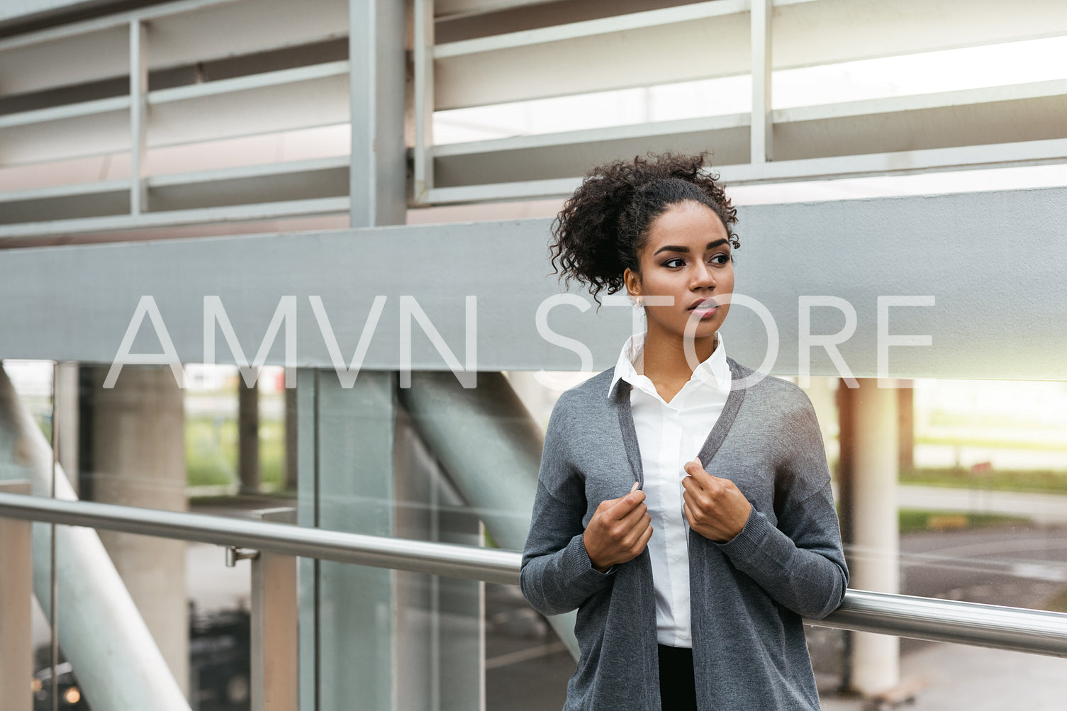 Serious businesswoman standing in airport terminal, looking away	