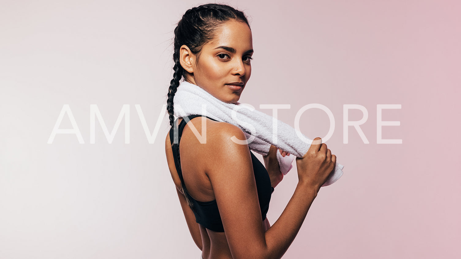 Beautiful mixed race woman in sportswear standing in studio looking at camera	