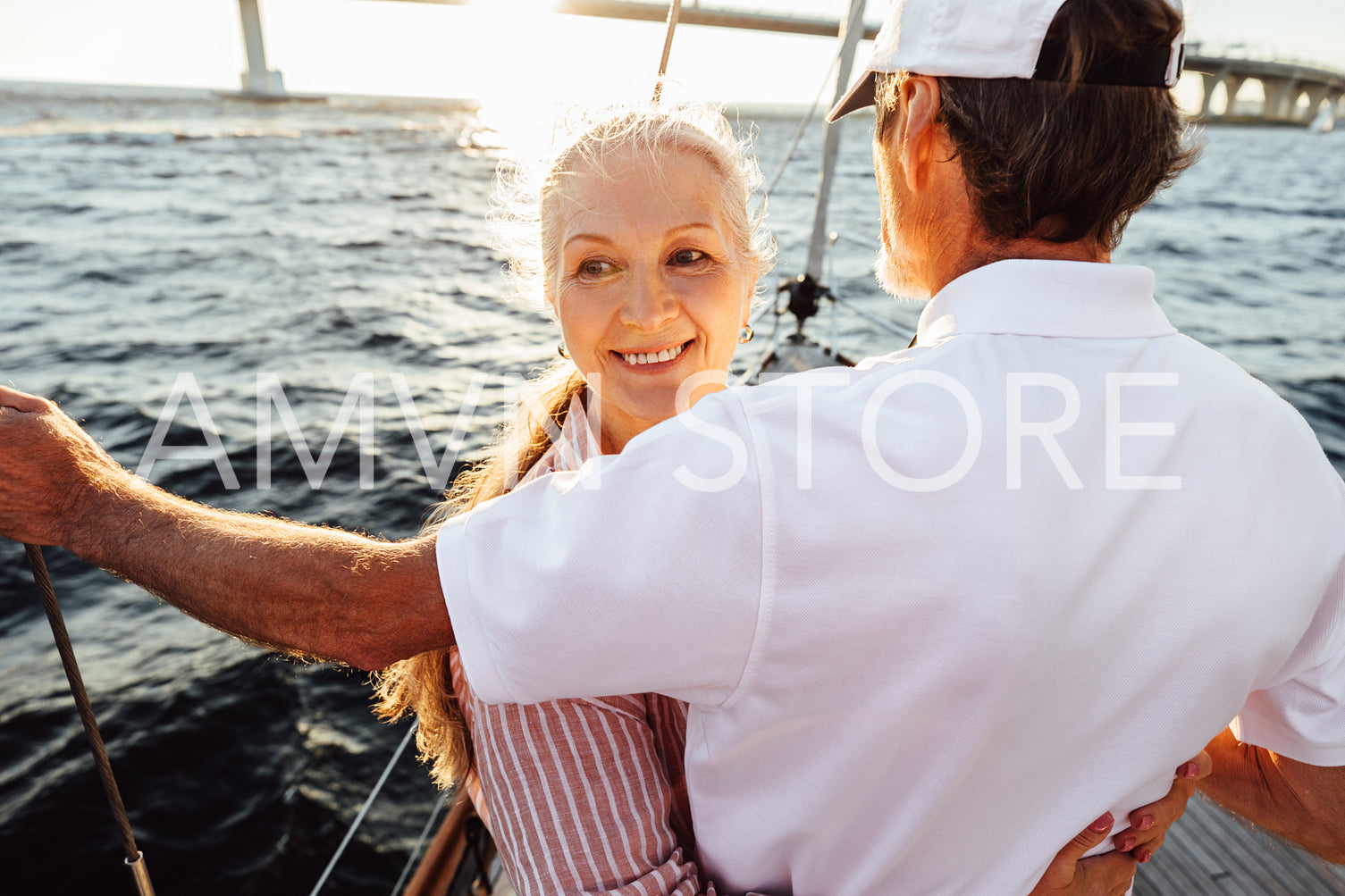 Portrait of a smiling mature woman hugging her husband and looking away	