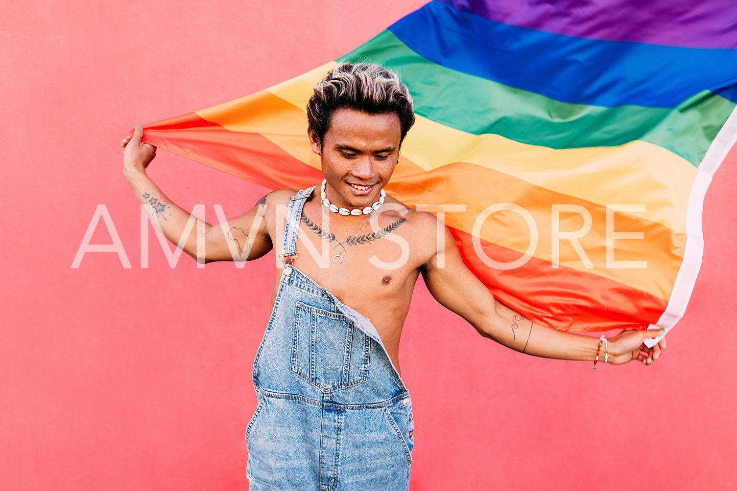 Happy guy with LGBT rainbow flag outdoors