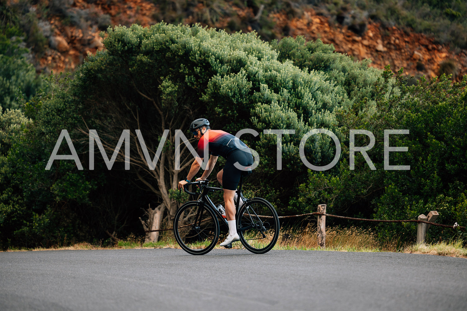 Back view of male cyclist riding a bicycle in wild terrain