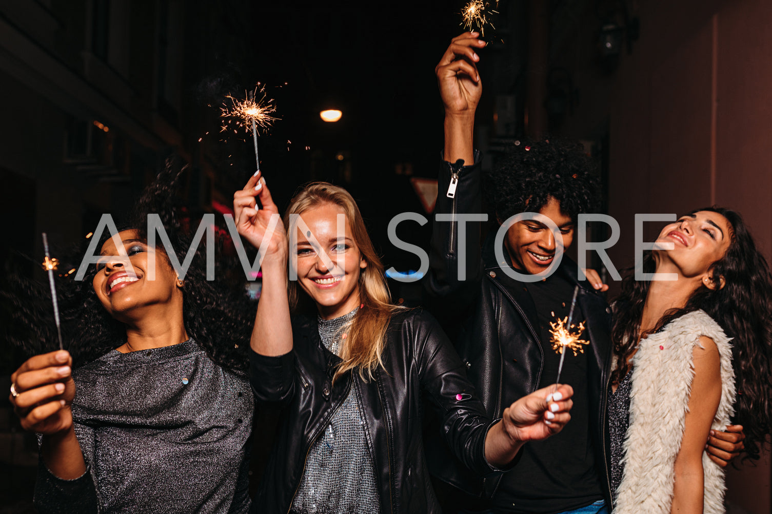 Four diverse friends having fun on night street	