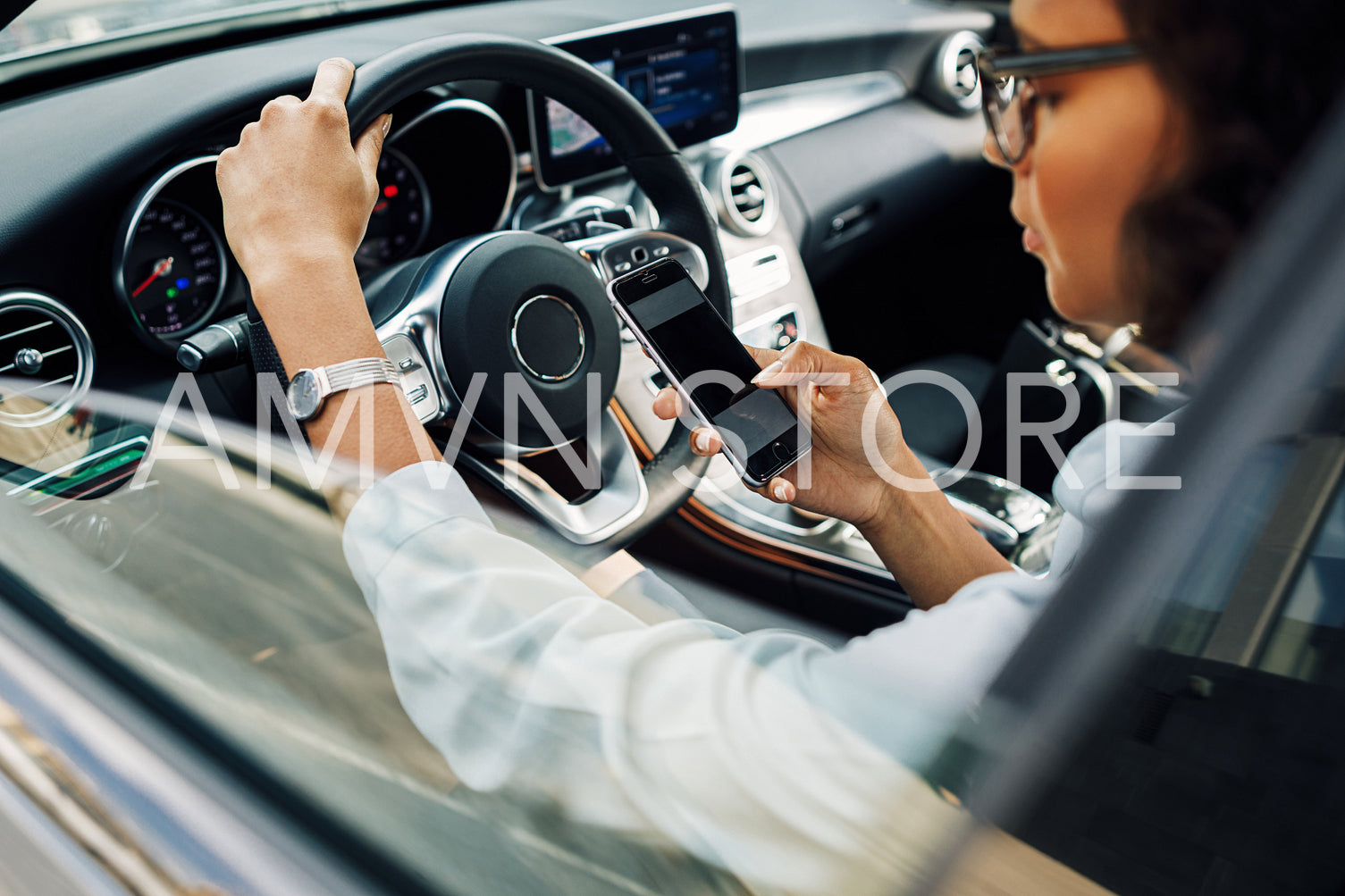 Unrecognizable woman using smartphone while sitting in car.	