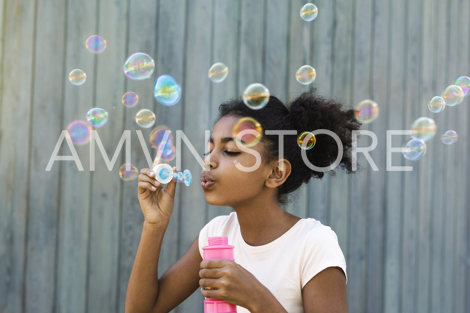 Portrait of cute girl blowing bubbles outdoors	