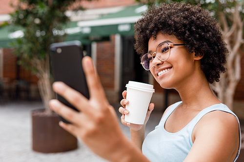 Social media influencer vlogging while drinking coffee to go