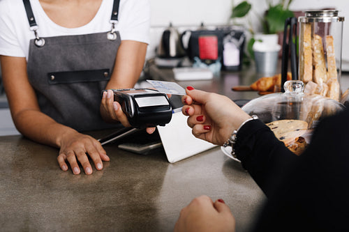 Customer making wireless payment using credit card with nfc technology