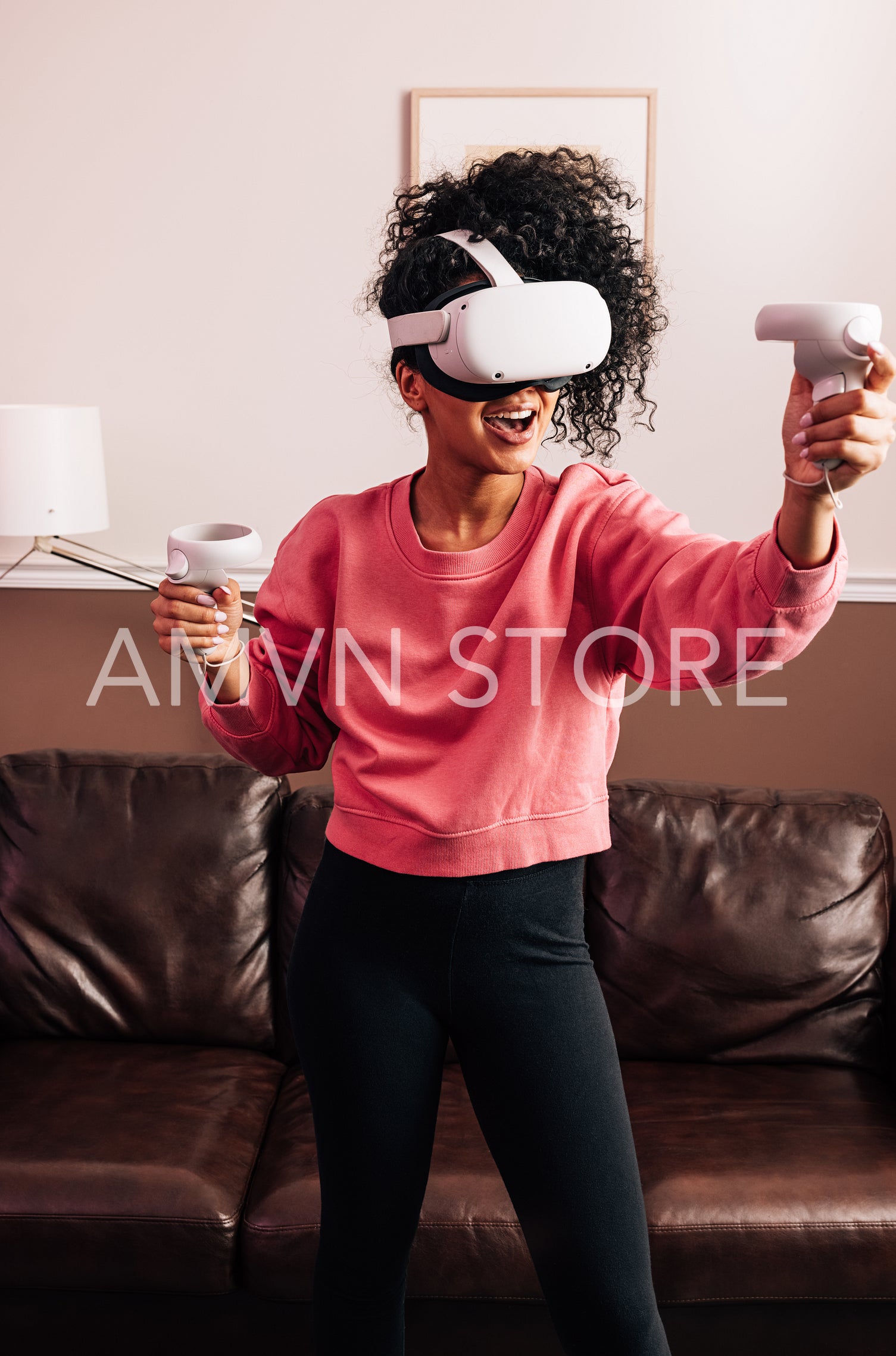 Woman with VR goggles and controllers in living room