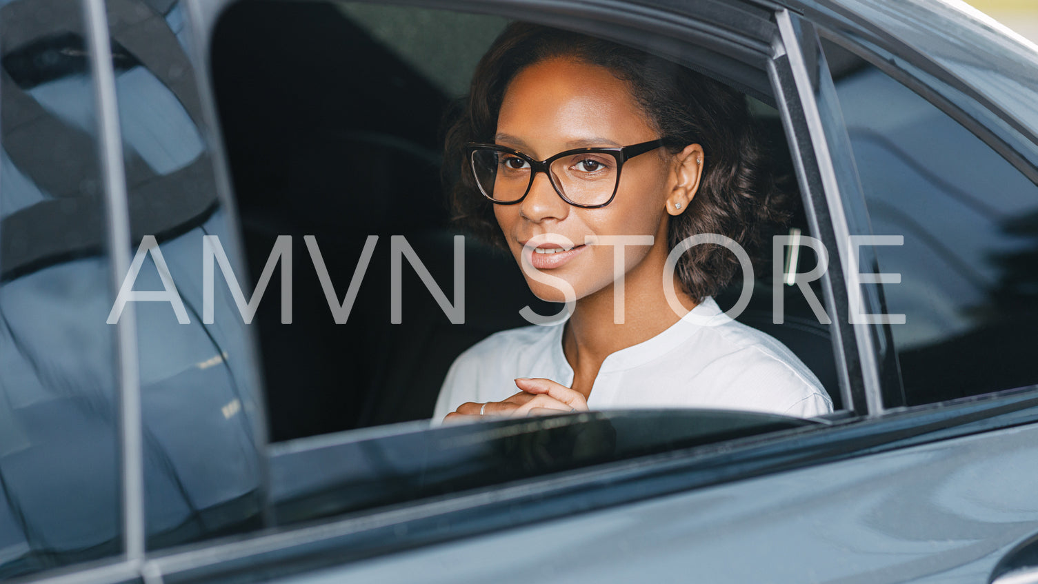 Beautiful businesswoman sitting on back seat of a car	