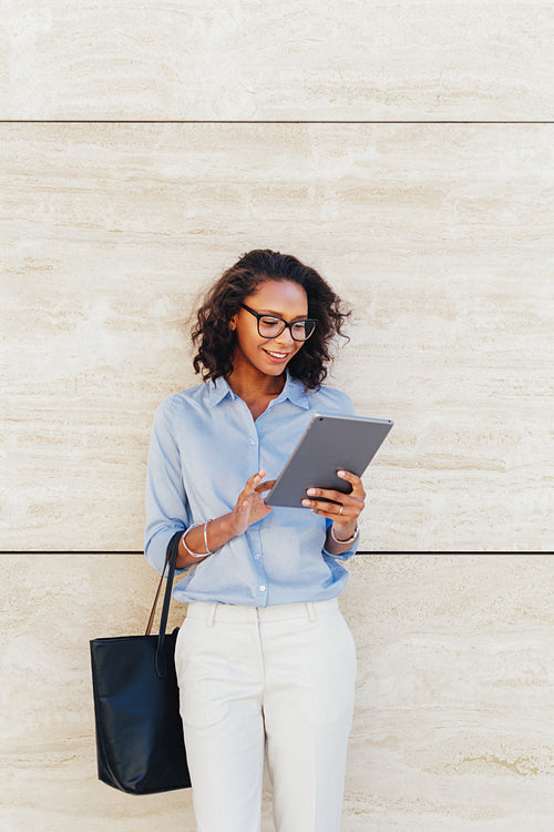 Woman reading from digital tablet