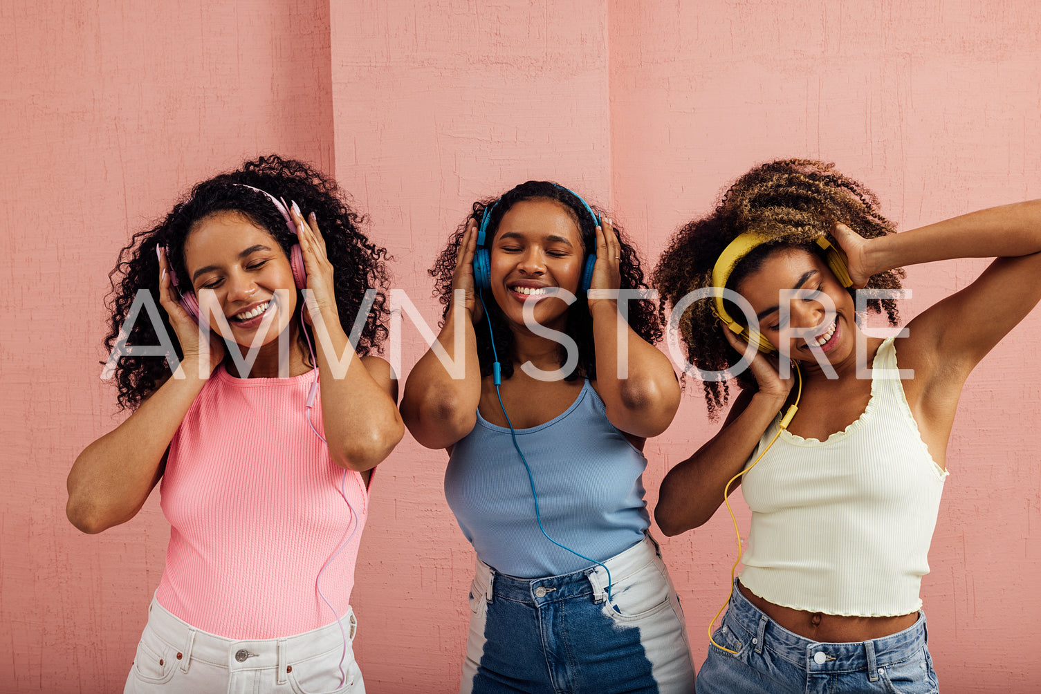 Group of young women enjoying music. Smiling females with headph