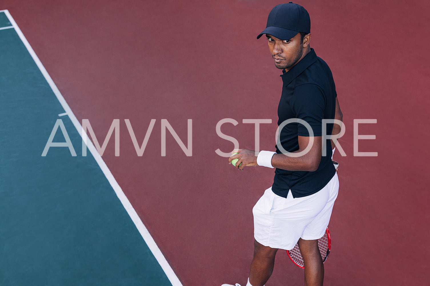 High angle of a young tennis player standing on hard court outdoors