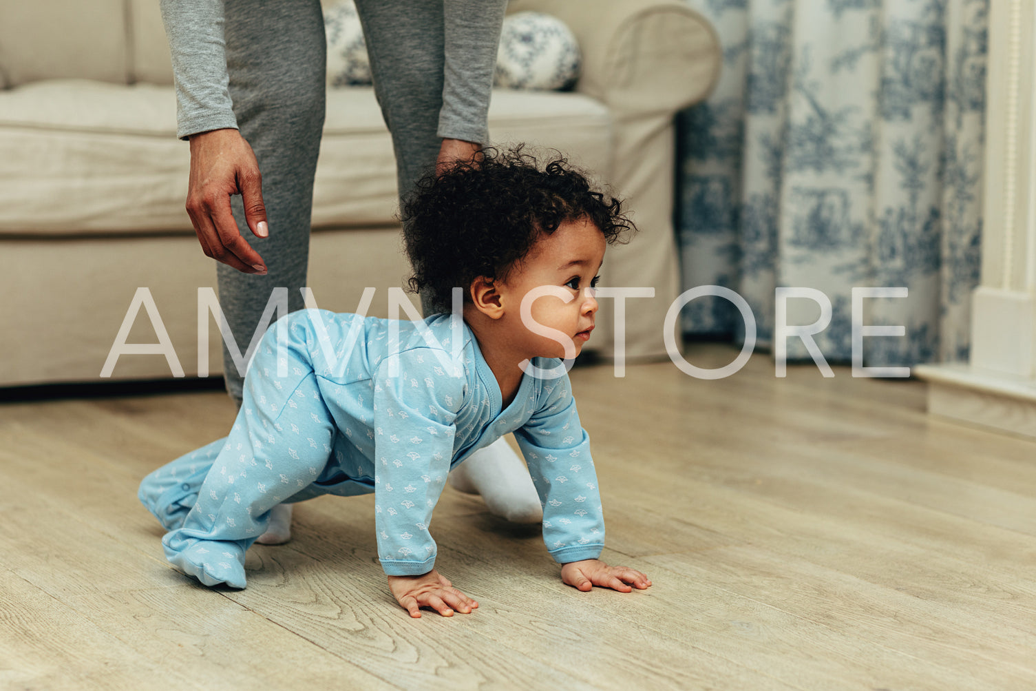 Side view of cute baby boy crawling on floor at home	