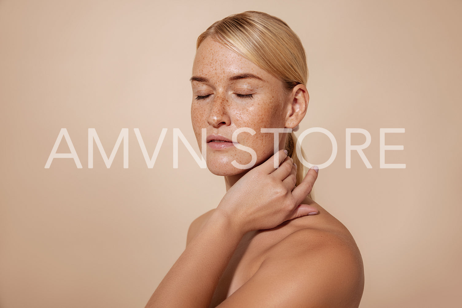 Caucasian female with freckles and blond hair standing with closed eyes massaging her neck