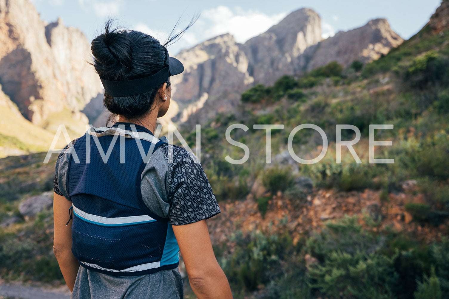 Woman in hiking attire looking at the mountains