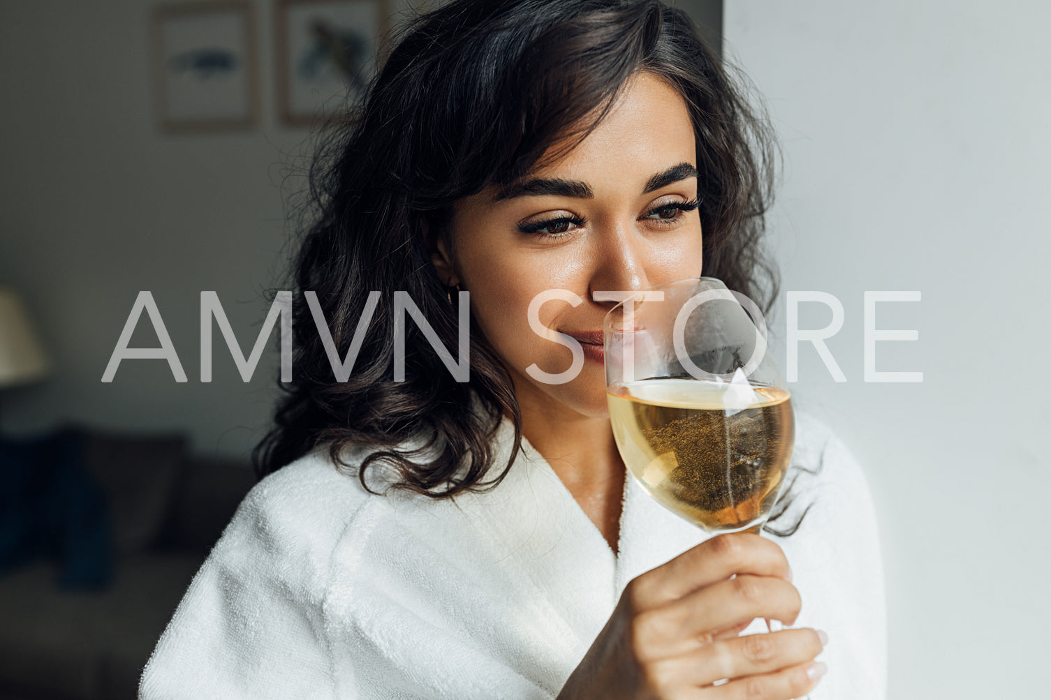 Beautiful female enjoying bocal of wine. Young woman relaxing at home.	