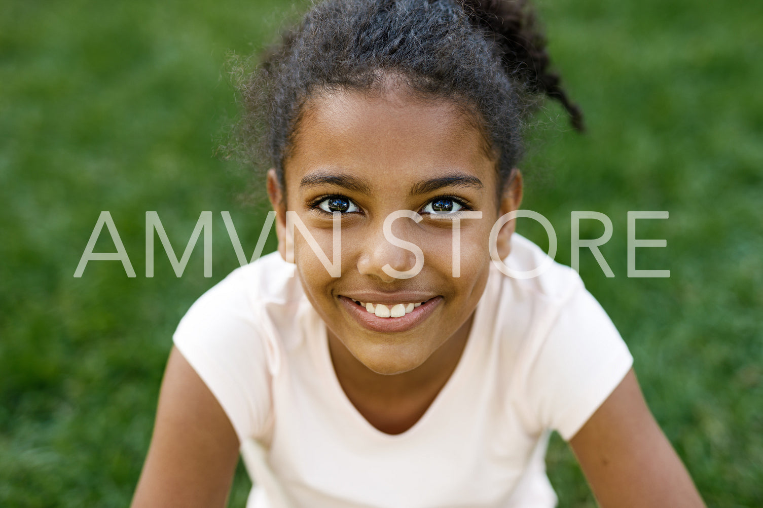 Close up portrait of cute smiling girl, sitting on grass	