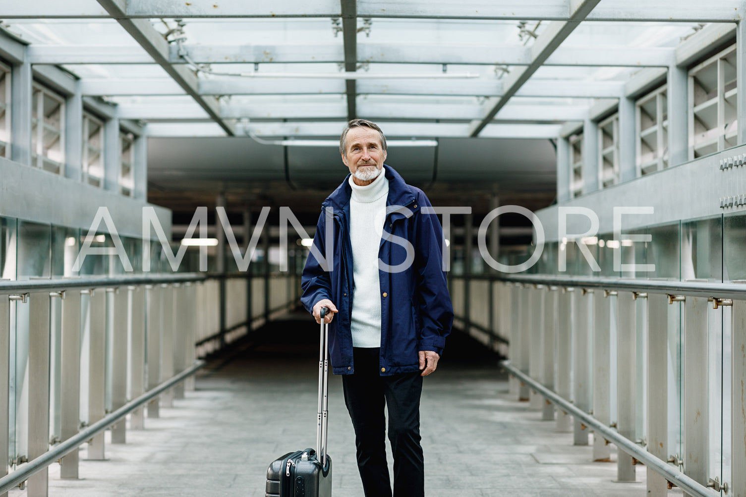 Mature male walking with suitcase on urban background	