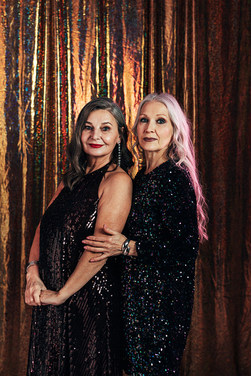 Portrait of two senior girlfriends posing together in the studio