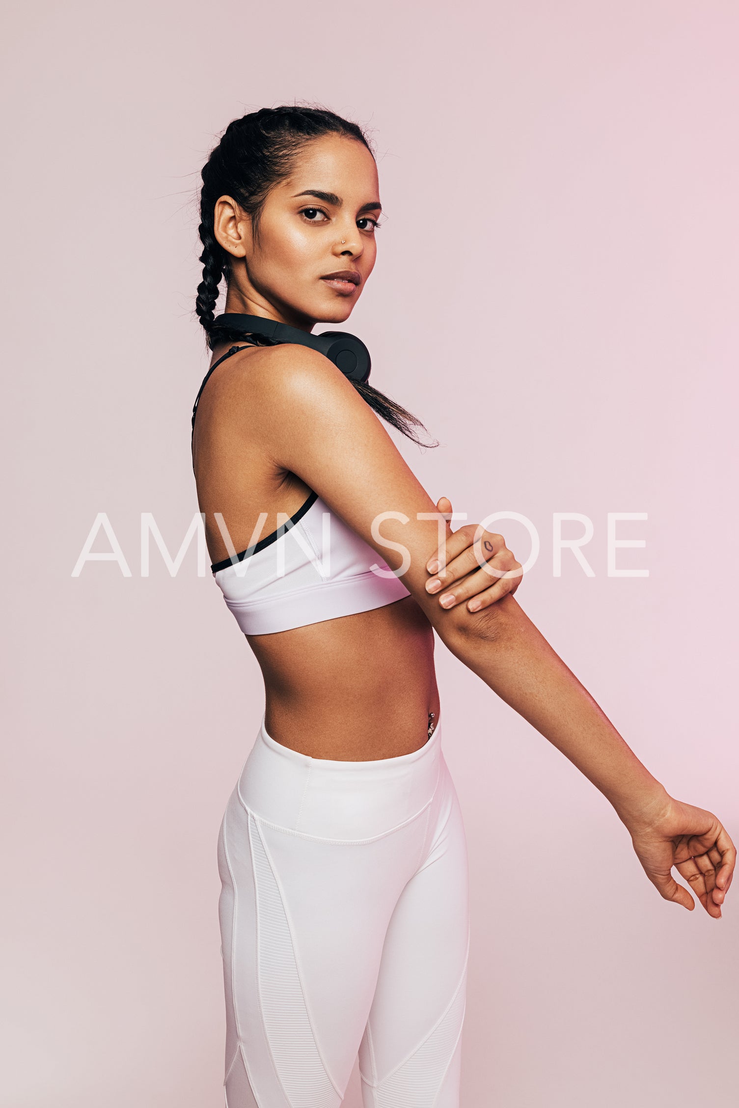 Side view of a young mixed race woman warming up her arm before exercises