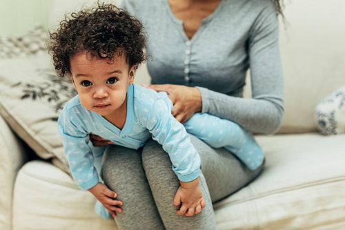 Portrait of a baby boy lying on mother lap