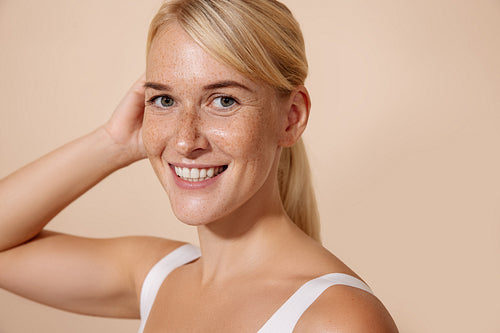 Smiling woman with freckles looking at camera. Portrait of a che