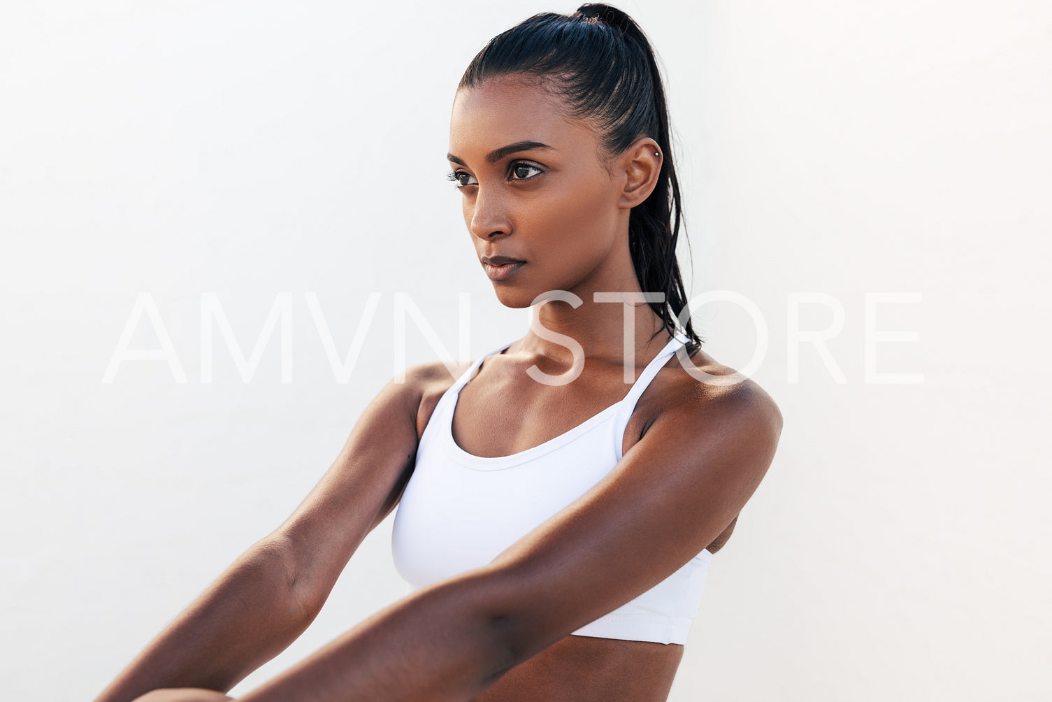 Muscular and confident fit female in white sports clothes