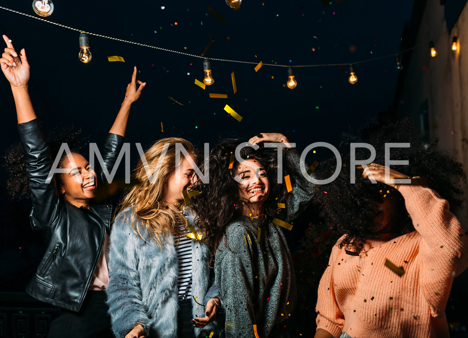 Group of female friends under confetti. Women having fun outdoors.	