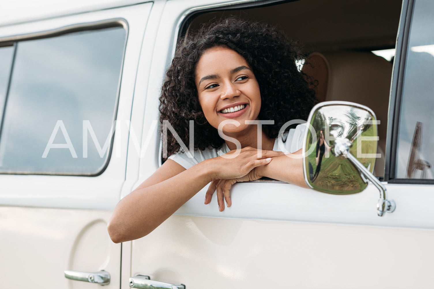 Young mixed race woman looking out of the car and smiling