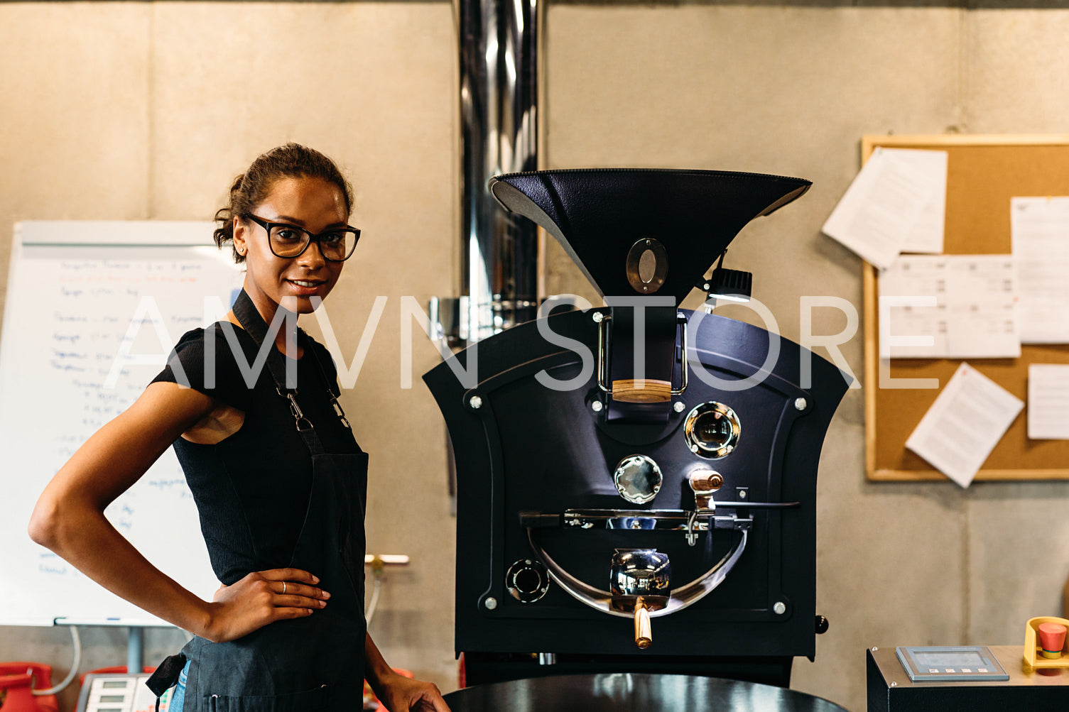 Small business owner standing in her coffee roasting shop	