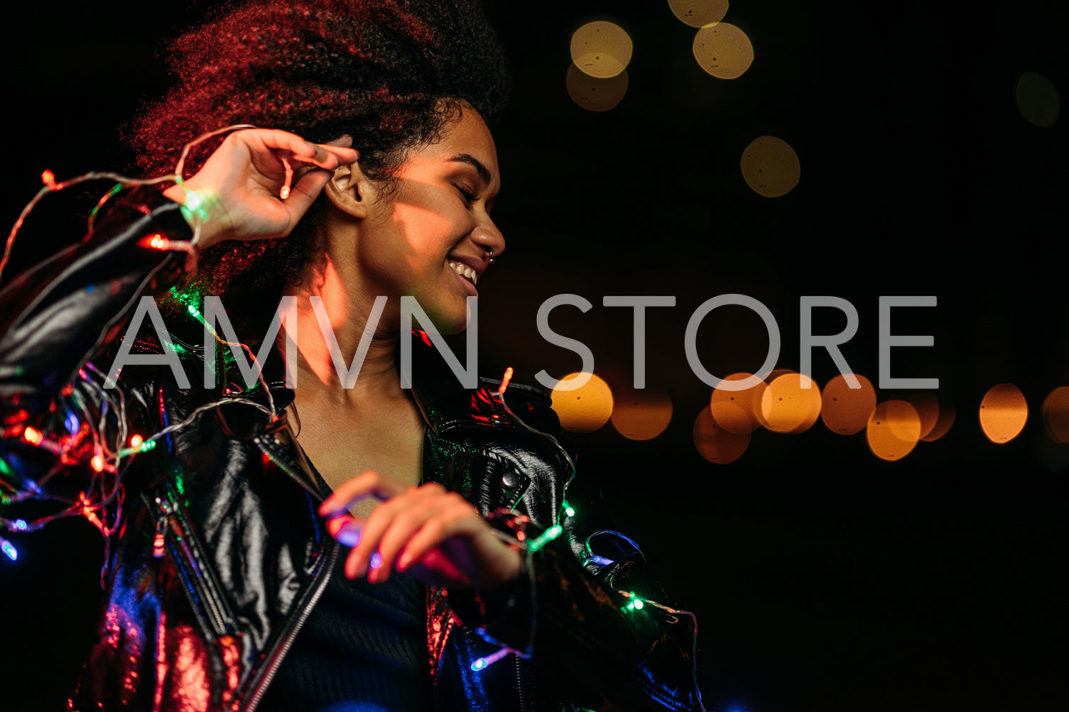 Side view of young woman posing at night in front of a city lights outdoors	