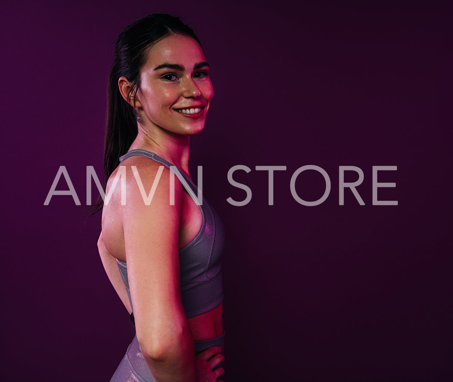 Side view of a healthy smiling female over magenta background in studio