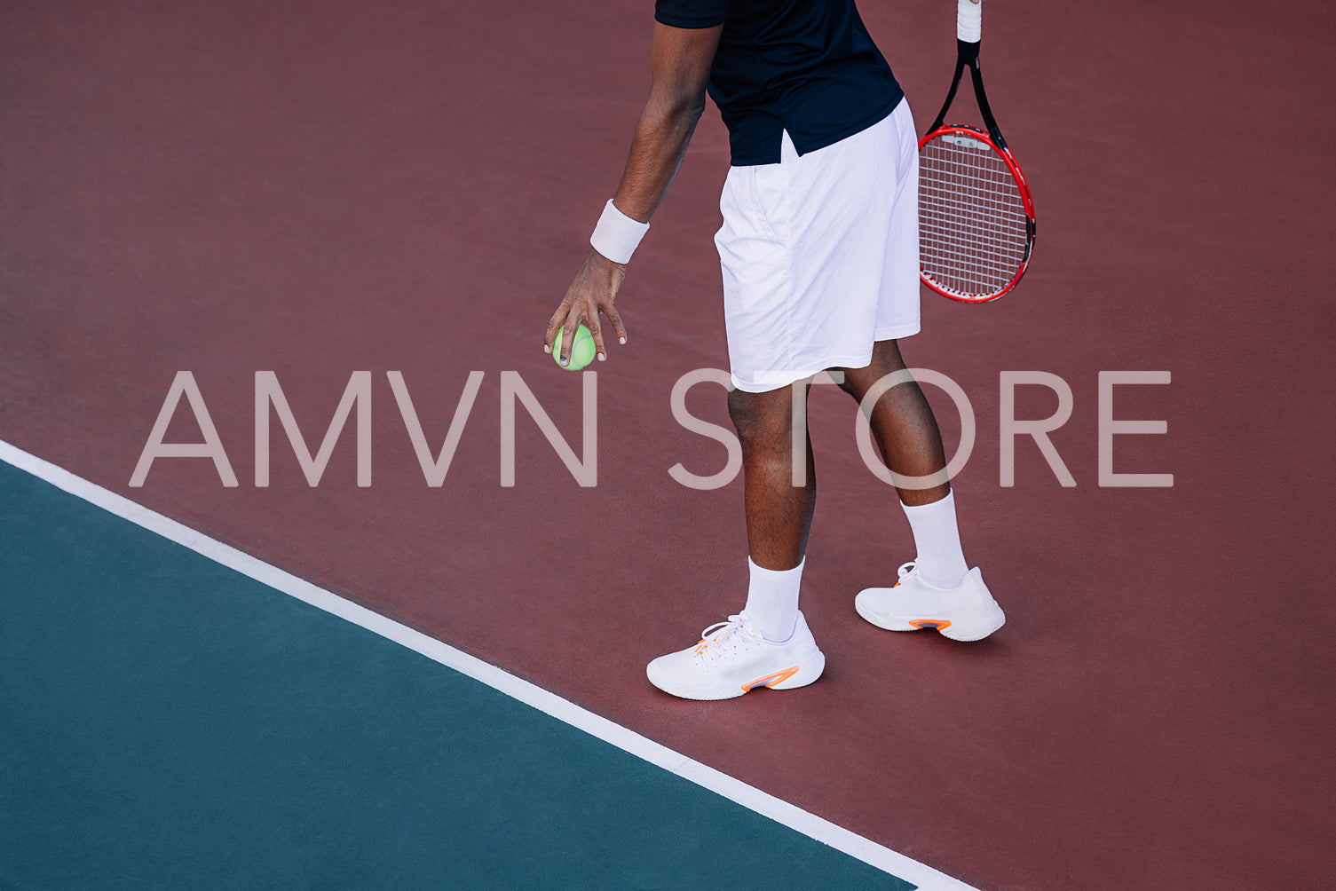 An unrecognizable tennis player bouncing a ball at baseline before serve