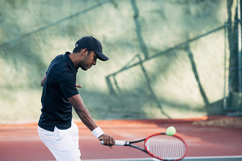 Professional tennis player returning the ball during a match