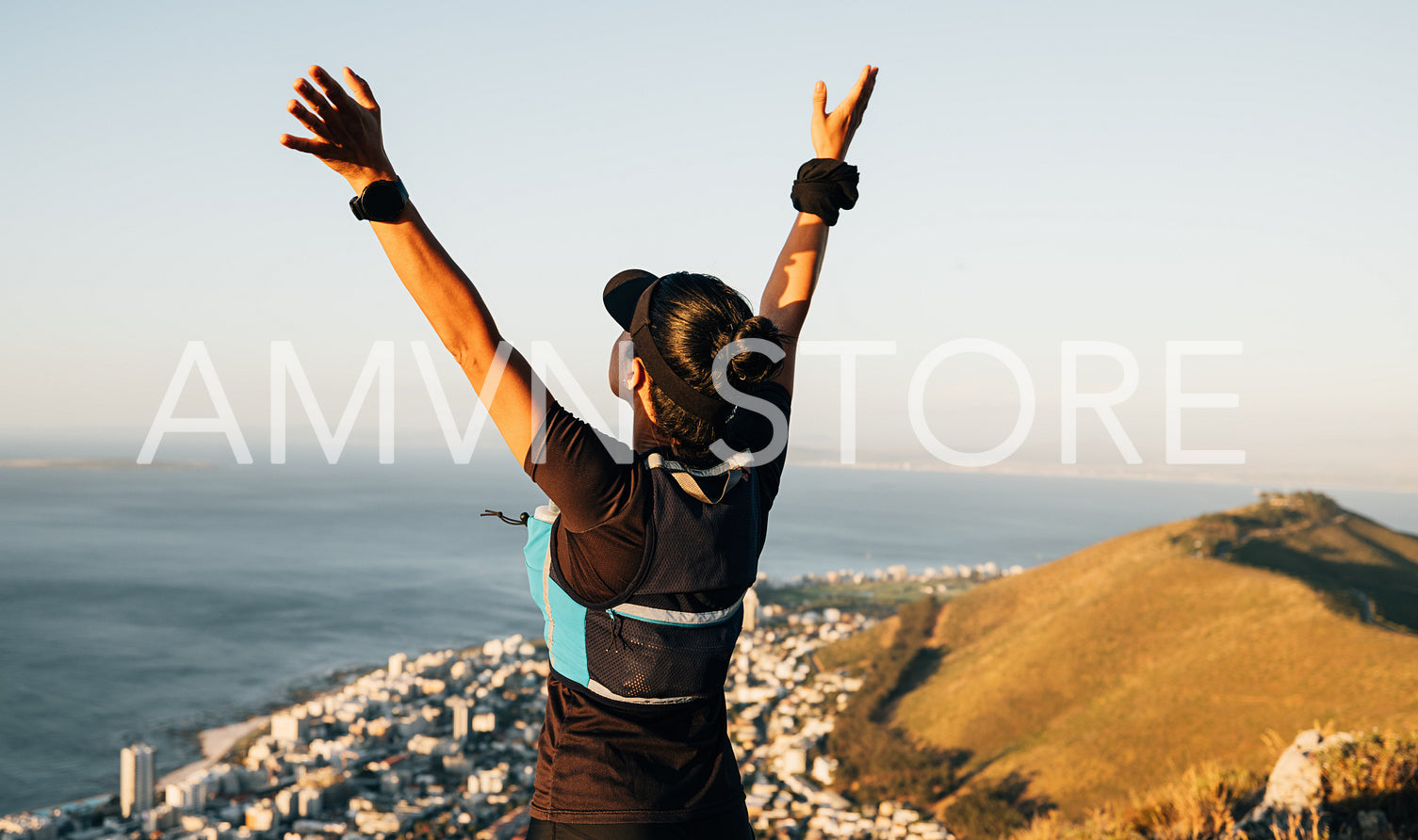 Happy woman hiker enjoying the view after climbing