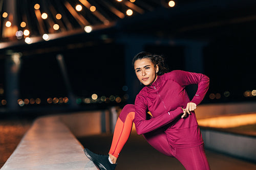 Middle east woman doing flexibility exercises outdoors at night