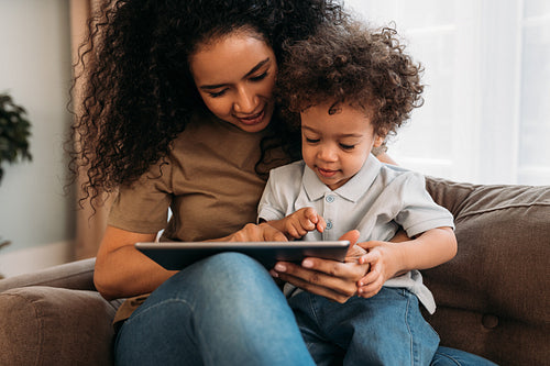 Mother and son using a digital tablet at home