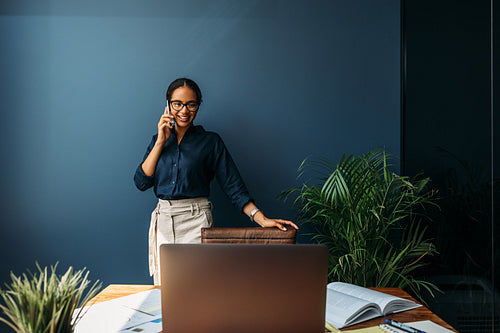 Female entrepreneur leaning to a chair in the home office while looking on a laptop screen