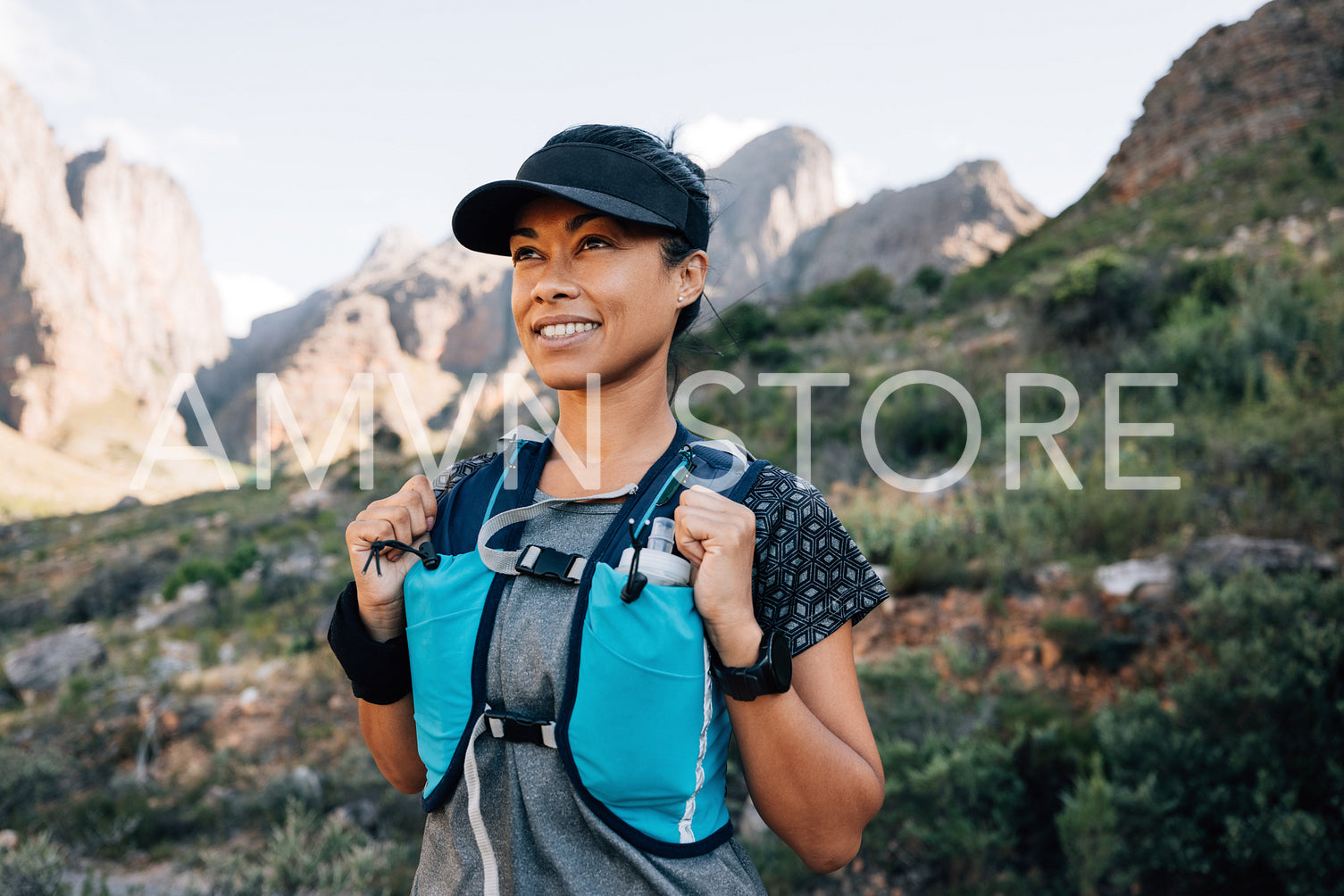 Portrait of a smiling woman in hiking attire looking away while