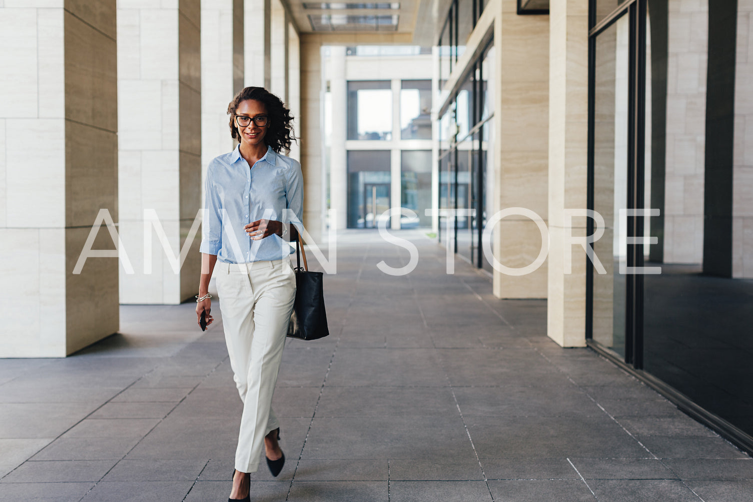 Woman walking from office with bag bag on her hand	