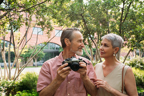 Senior couple looking at each other while standing in the park