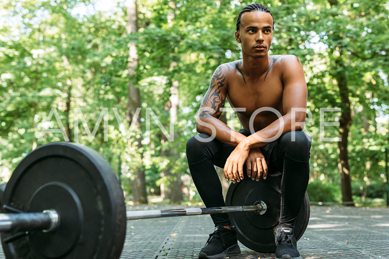 Athlete sitting on a barbell resting during exercises	