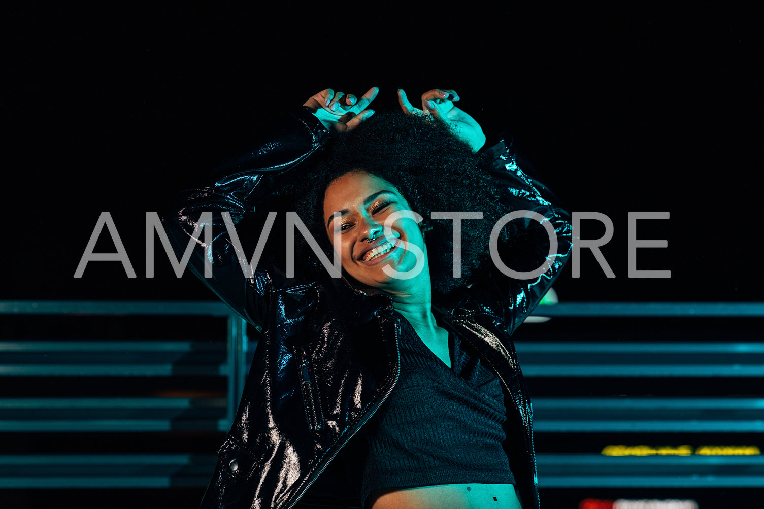 Young happy woman having fun on a roof at night. Smiling female posing outdoors with closed eyes.	