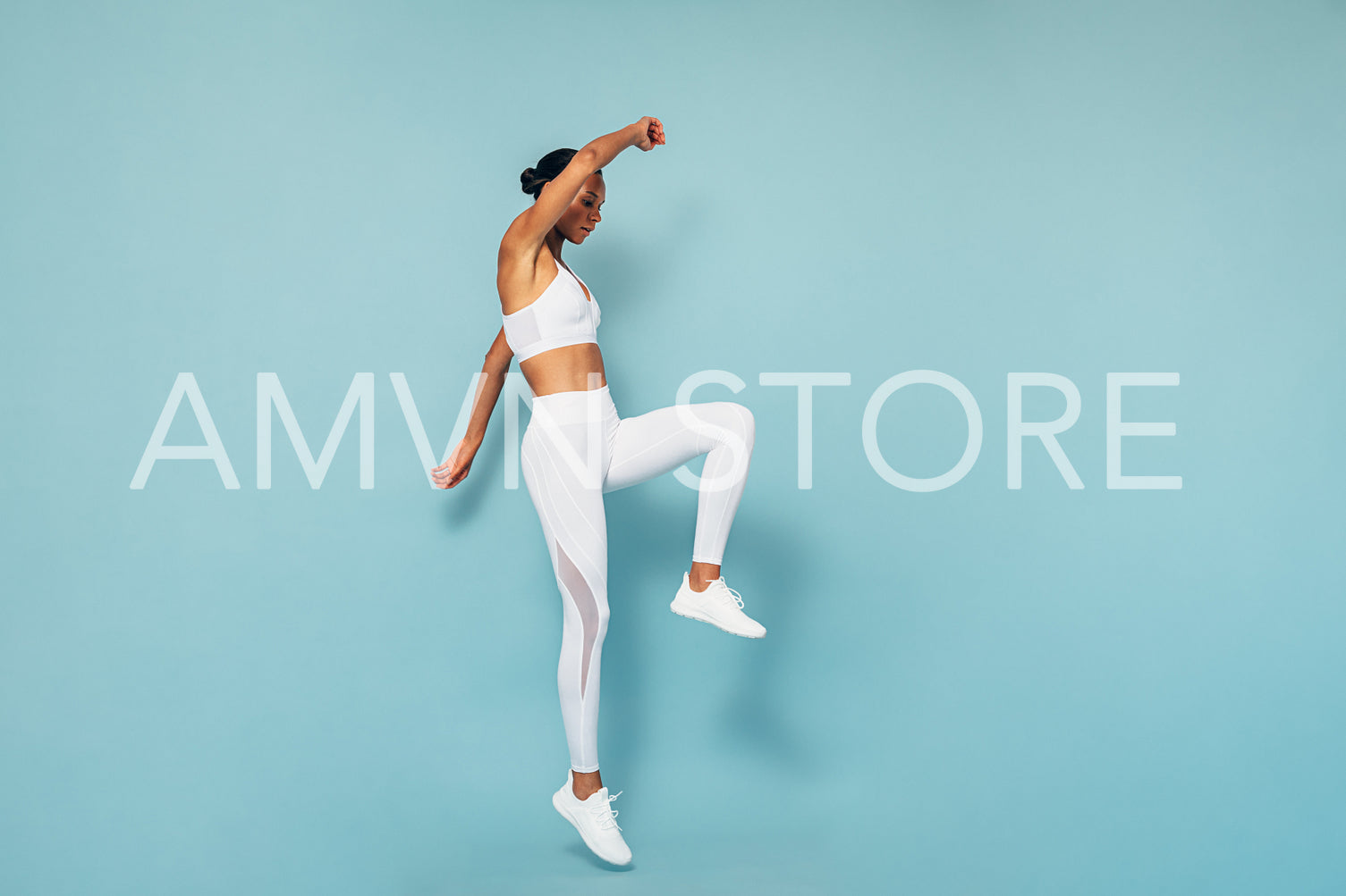 Sports woman jumping over blue background, warming up	