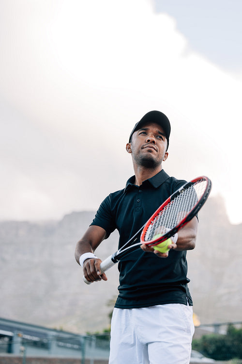 Tennis player preparing to serve the ball in a match